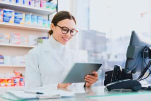 Young, female pharmacist working on iPad