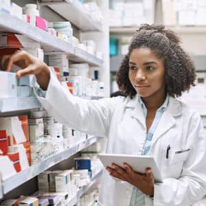 Young, female pharmacist filling a prescription